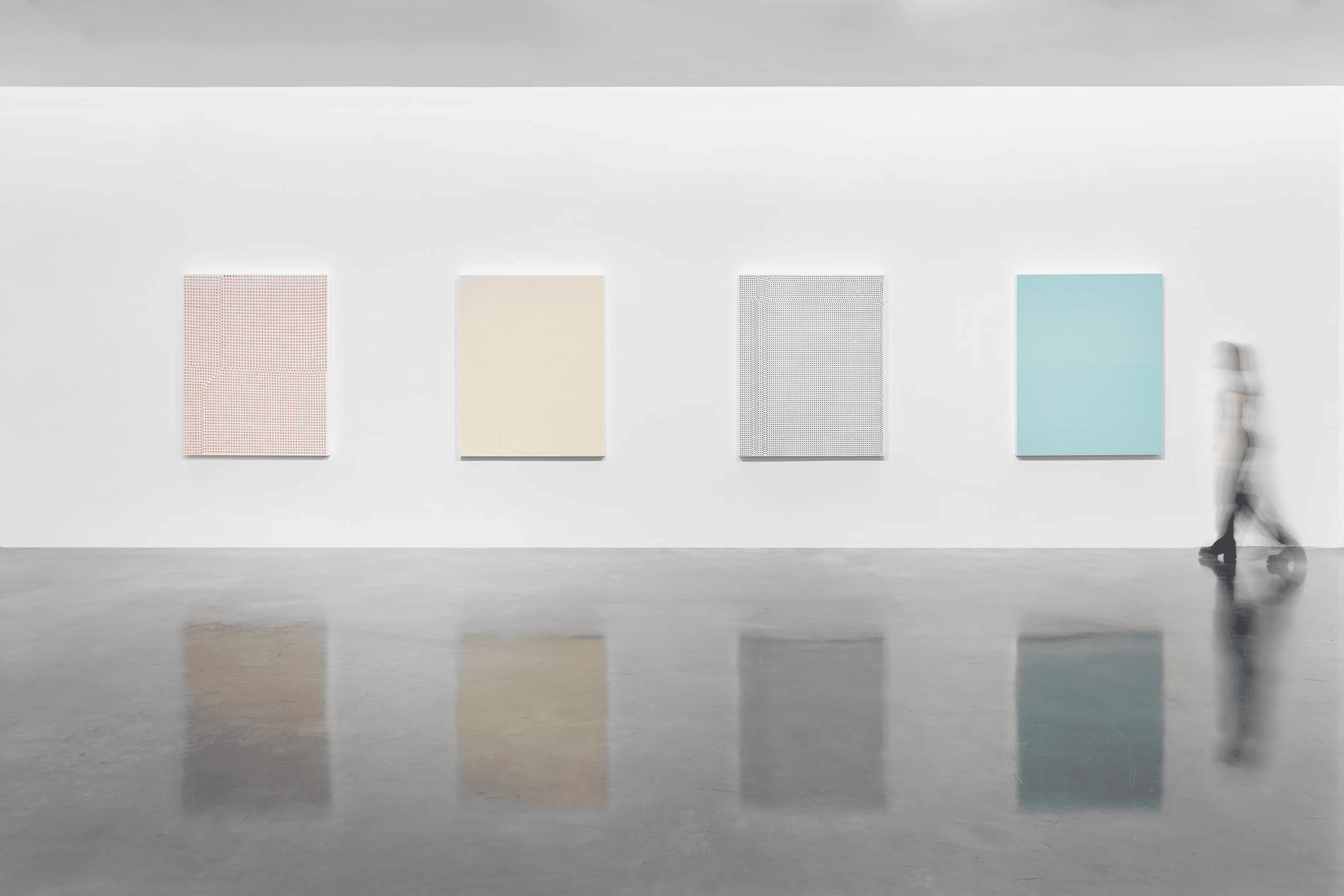 A visitor walks by four of the 12 large-scale paintings exhibited in 2023 at the PACE Gallery in New York